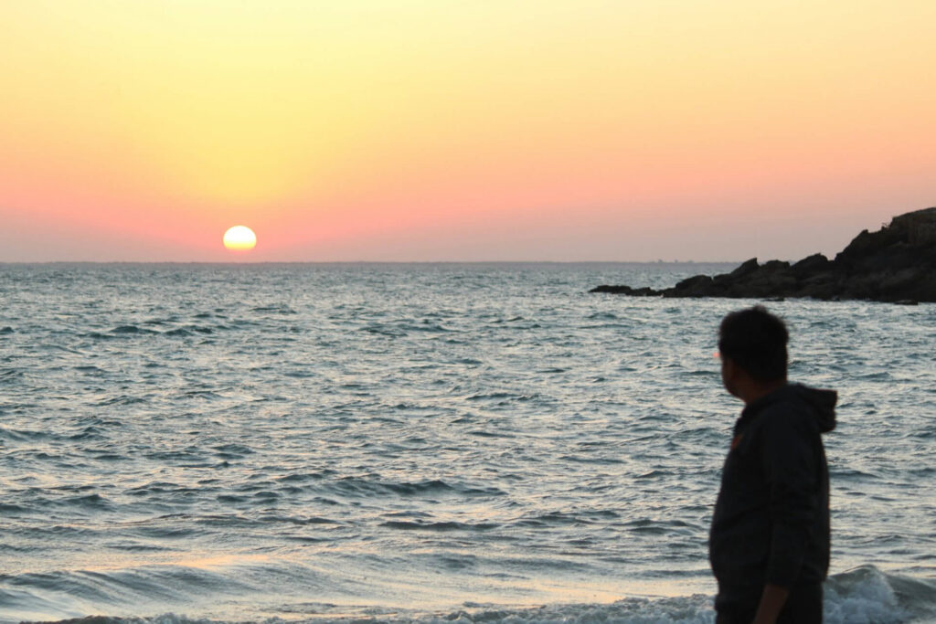 man watching sunset