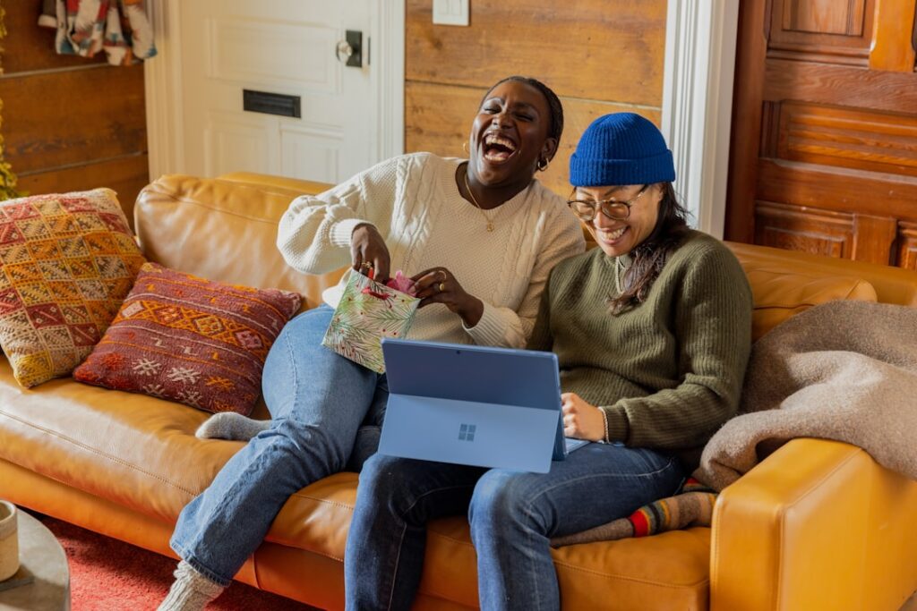 two women sitting on a couch