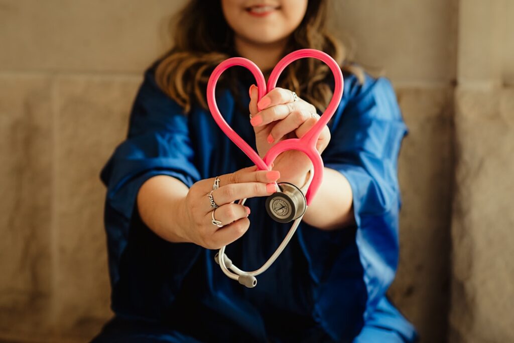 heart stethoscope being held by a woman