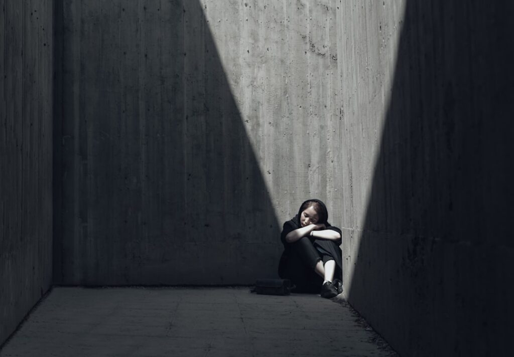 girl sitting in a room corner