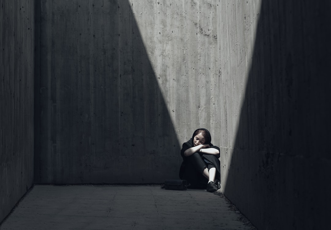 girl sitting in a room corner