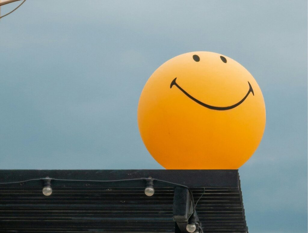 yellow balloon with smiley face