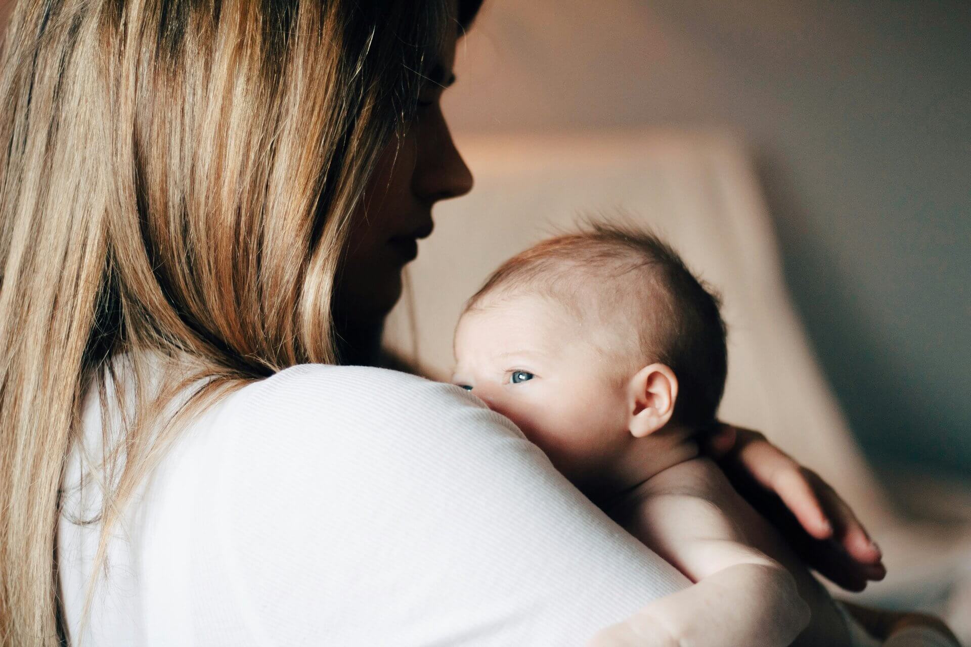 women holding baby