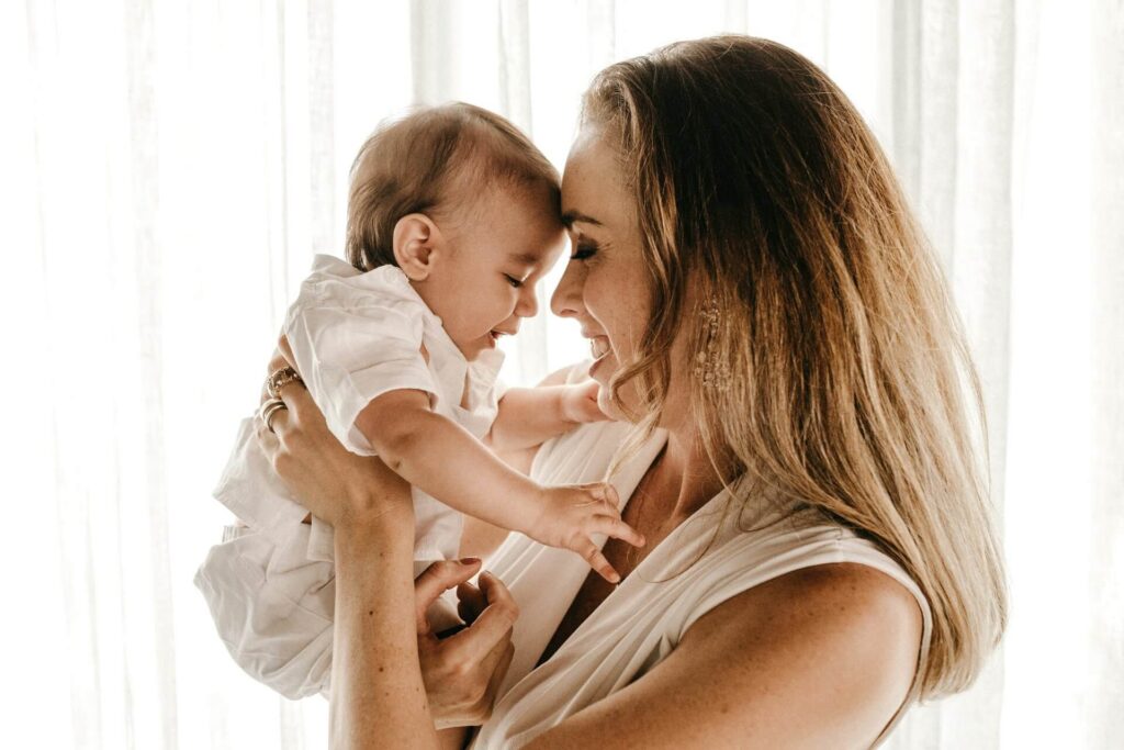 woman holding a baby and laughing