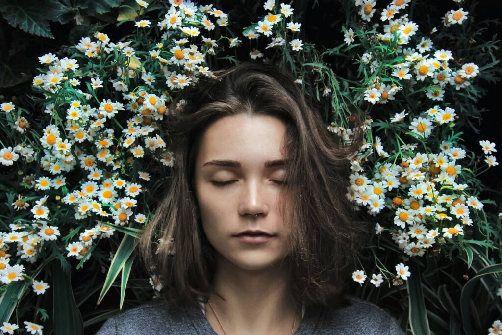 girl lying in a bed of flowers